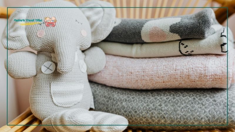 baby toy and blankets. Prepare for flight- How to Fly With a Newborn