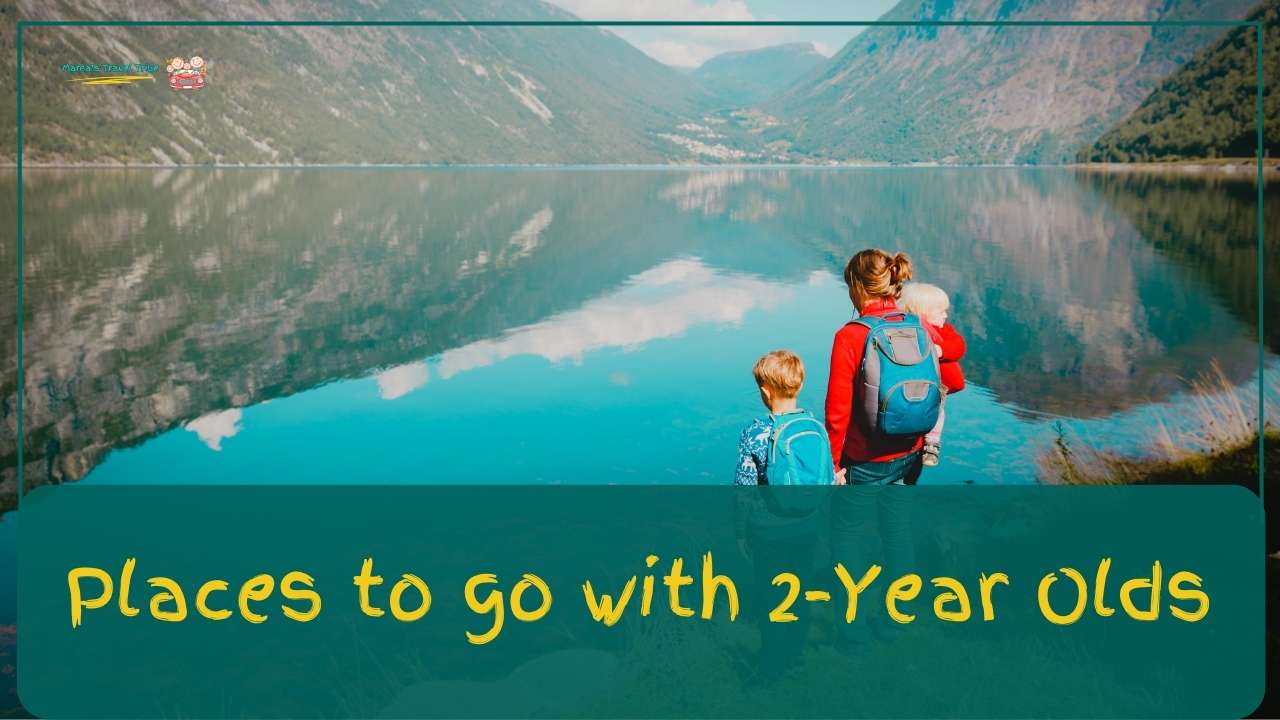 Family of mother and 2 children standing near the edge of a water body with their backs towards the camera. places to go with 2 year olds