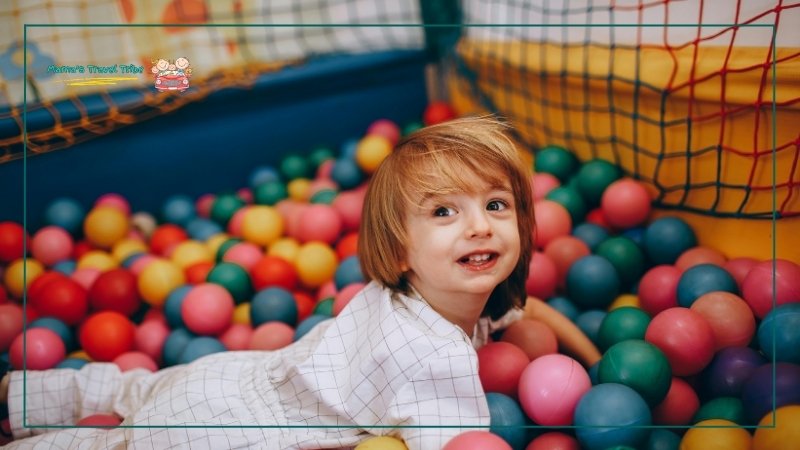 Indoor Play Centers, child in a ball pit. places to go with 2 year olds