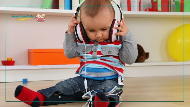 baby sitting with headphones on ears. Do Babies Need Headphones on Planes