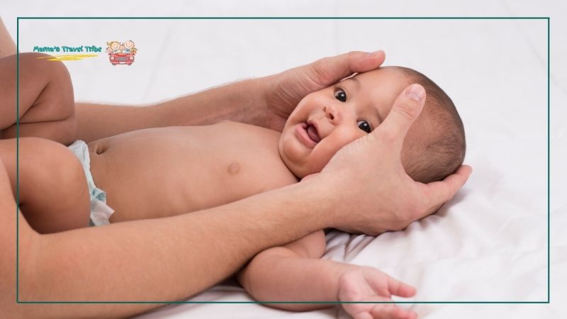 baby getting head massage. massage your baby's ears if you don't have headphones. do babies need headphones on planes.