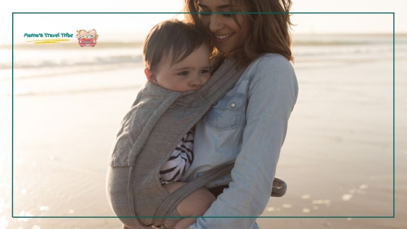 mom holding a baby in a wearable carrier. do babies need passport to go on cruise