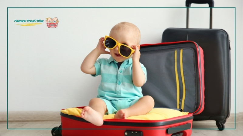 baby sitting in a suitcase. tips for flying with a 1 year old