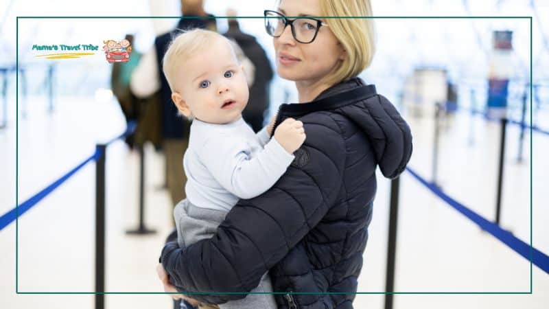 Best travel hacks for moms, baby in mom's arms on airport standing in airport line