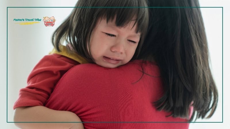 Baby girl crying on mother's shoulder. best trips with toddlers. Trips and Activities by Age: Where to Go With Babies, Toddlers, and Preschoolers