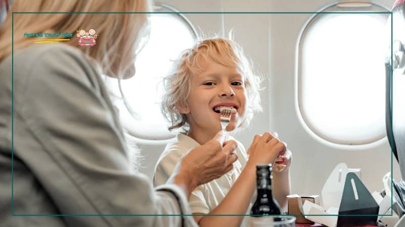 child eating on plane. mother feeding child on plane. Flying With Kids: The Complete Air Travel Guide for Babies and Toddlers