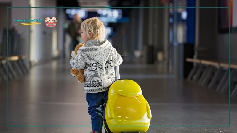 Child walking on airport alone with bag. Flying With Kids: The Complete Air Travel Guide for Babies and Toddlers