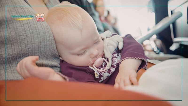 infant sleeping on mom's lap on airplane. tips for flying with ticketed child vs lap infant. what do kids need to fly. 